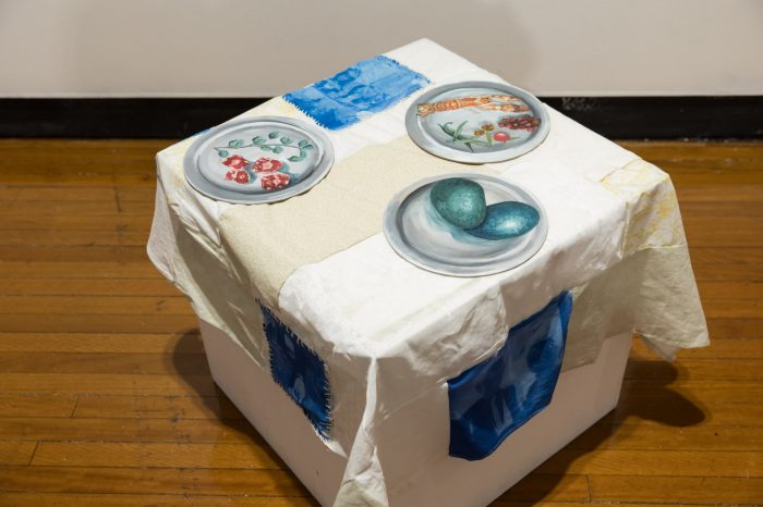 Leilani Knight, ‘Mother's Meals’ 2025. Oil paint, solar-print, canvas, found textiles, cork board; Wall works: Mother’s Meals, 61 x 81.5cm, Pint, 25 x 25cm, Bottlecap Memoirs, 25 x 25cm, Emu Hassling, 25 x 25cm; On plinth: Emu Eggs, 25 x 25cm, Yabby and Seeds, 25 x 25cm, Kangaroo and Saltbush, 25 x 25cm. 