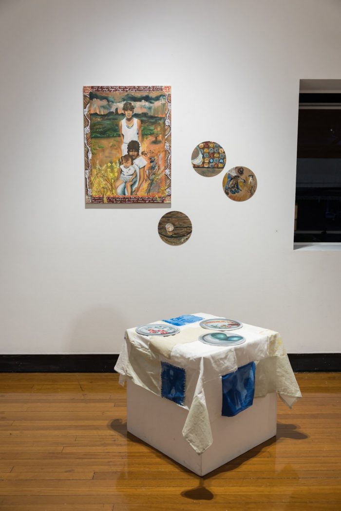 Leilani Knight, ‘Mother's Meals’ 2025. Oil paint, solar-print, canvas, found textiles, cork board; Wall works: Mother’s Meals, 61 x 81.5cm, Pint, 25 x 25cm, Bottlecap Memoirs, 25 x 25cm, Emu Hassling, 25 x 25cm; On plinth: Emu Eggs, 25 x 25cm, Yabby and Seeds, 25 x 25cm, Kangaroo and Saltbush, 25 x 25cm. 