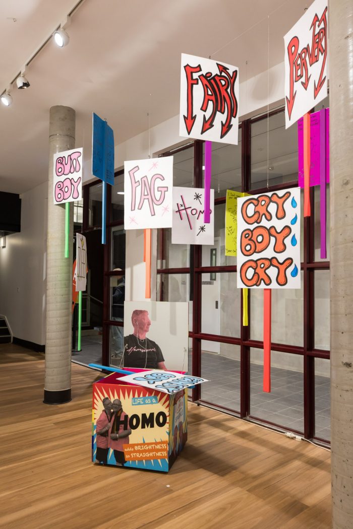 Mark Wilson, ‘I have (something) a lot to say’ 2025. Acrylic screen print and aerosol on wood, paint marker, paper and corflute; Box: 60 x 60 x 60cm each; Pickets: approx. 120 x 55cm each.