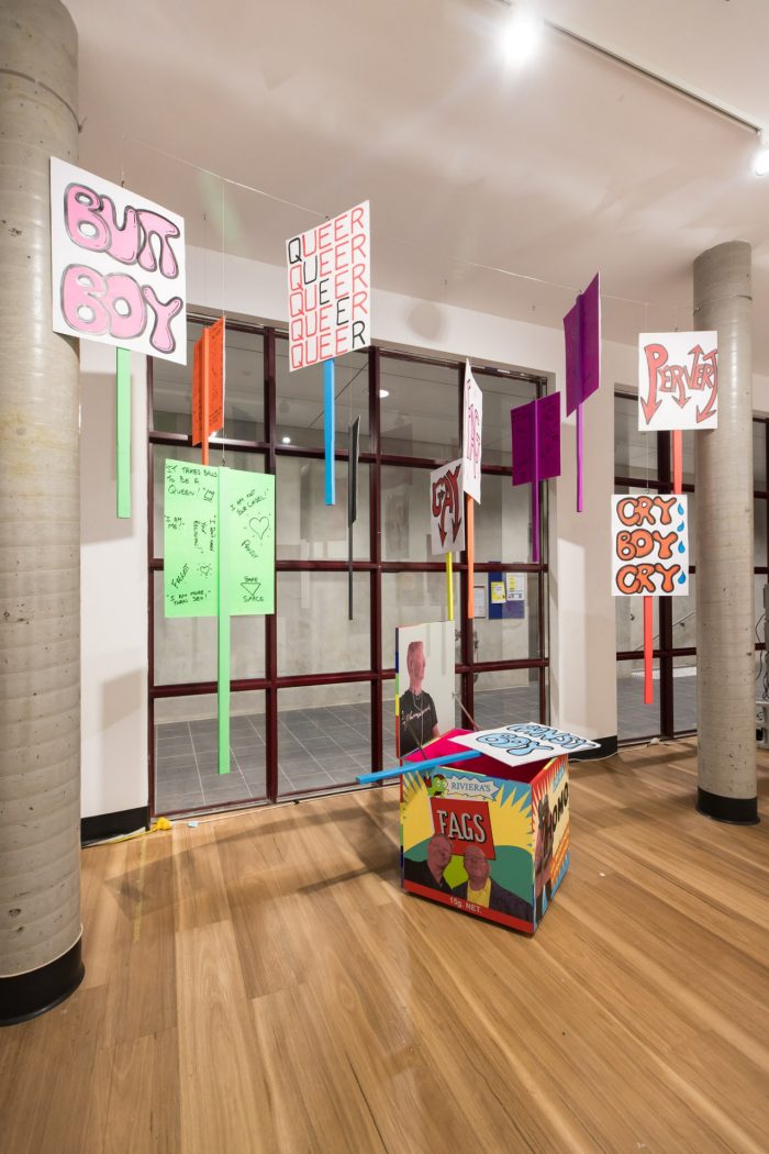 Mark Wilson, ‘I have (something) a lot to say’ 2025. Acrylic screen print and aerosol on wood, paint marker, paper and corflute; Box: 60 x 60 x 60cm each; Pickets: approx. 120 x 55cm each.