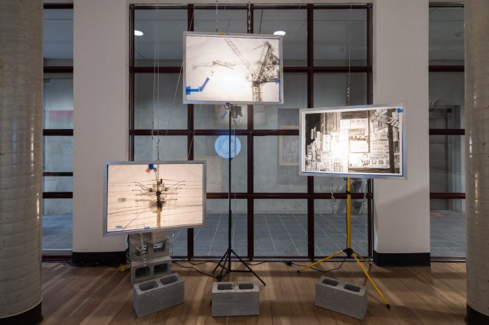 Eric Kang, ‘Leviathan’ (2025). Traditional Korean ink on tracing paper with aluminium frames, wire rope assembly, tape, work lights and concrete blocks; 3 panels: 60cm x 85cm each. Photograph: Anna Kucera.