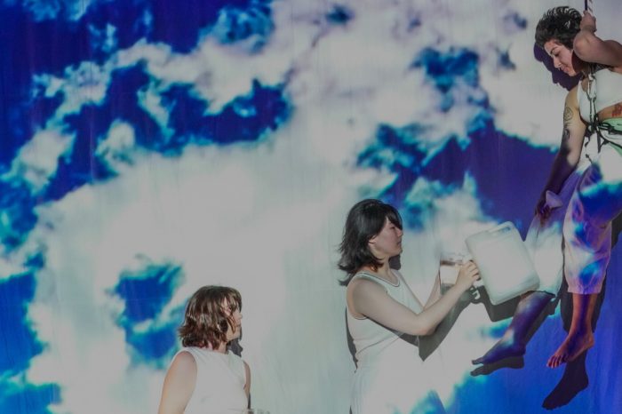 three female theatre students on stage one suspended from rope