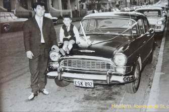 An image of a guy and a boy dressed up  next to a 1960s Humber 