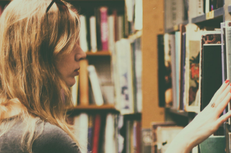Student reading a book in library
