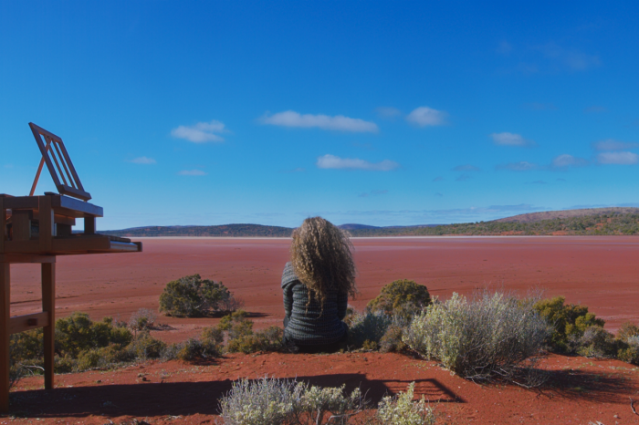 Duet for One-Girl sitting on desert sand