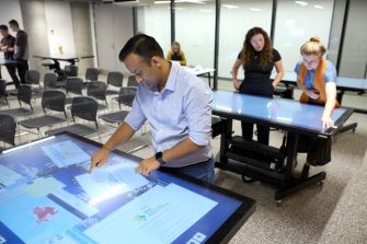 Students using technology in the City Futures Lab at the School of Built Environment