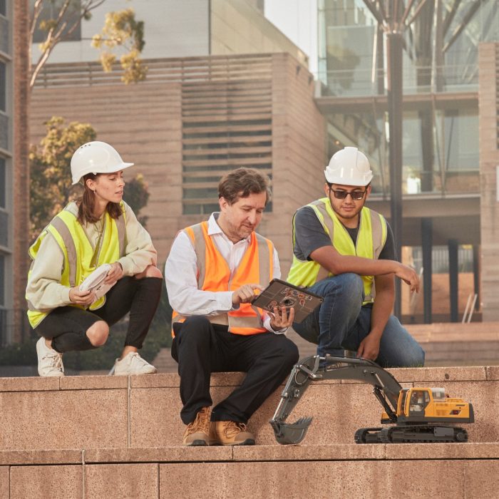 Students and teacher operate learning via practice operating heavy machinery.
