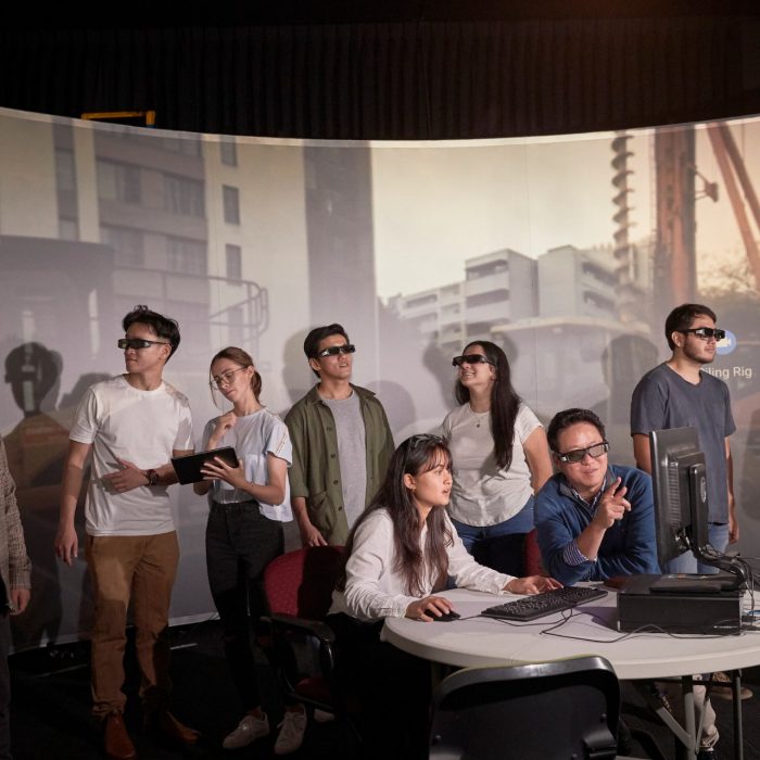 Students and teacher operate learning in a virtual reality cinema.