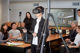 Students and teacher operate learning in a virtual reality cinema.