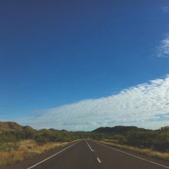 Empty asphalt road under blue sky.