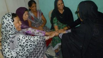 Women holding hands in a circle