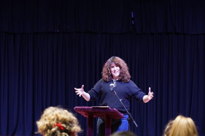 speaker at lectern with audience in the foreground