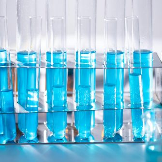 A row of test tubes containing blue liquid