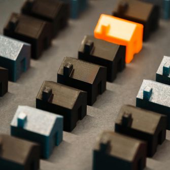 Rows of differently coloured 3D-printed model houses