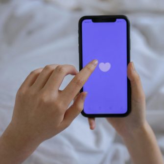 Person using phone in bed