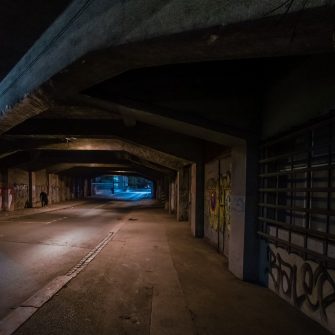 Dark empty underpass with blue street lights