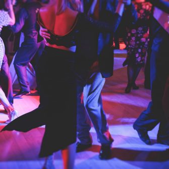 Couples dancing traditional latin argentinian dance milonga in a ballroom