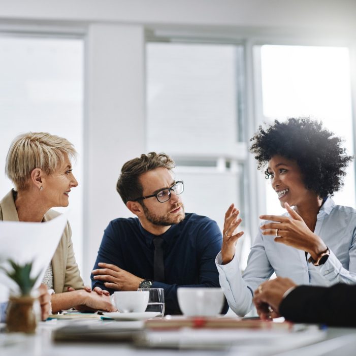 Shot of a group of businesspeople sitting together in a meeting
