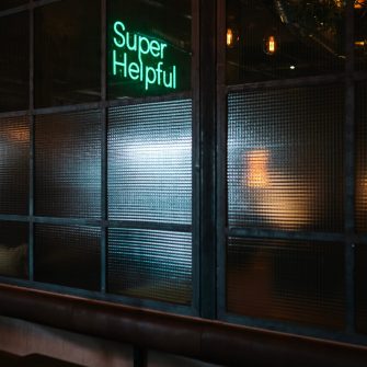 Super Helpful neon sign at night