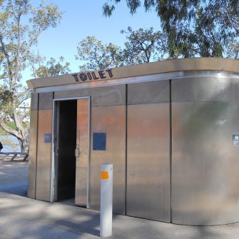 A silver outdoor public restroom