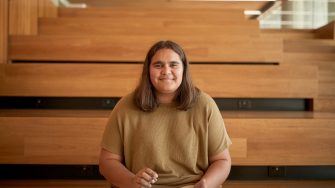 Art and design students discussing work inside the Red Center build enviroment study space.