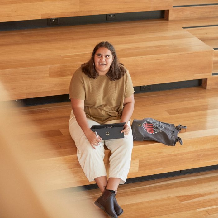 Art and design students discussing work inside the Red Center build enviroment study space.