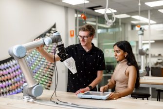 ADA students working with a collaborative robot.