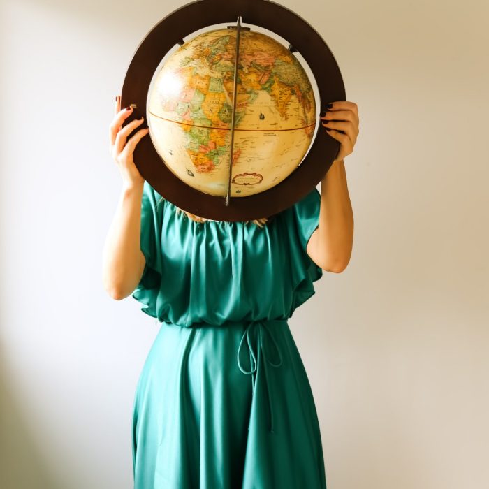 a woman holding a globe in front of her face