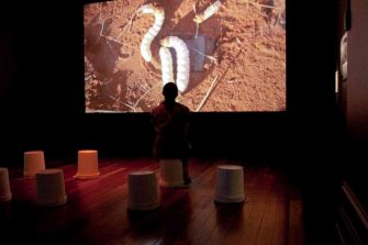 Photo of Lily Hibberd (artist/curator) showing Mamu (2010) by Curtis Taylor commissioned for Spaced 2: Future Recall, Perth International Festival of the Arts, Museum of Western Australia