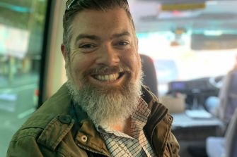 Headshot of Tom Dawkins on Road Trip bus