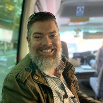 Headshot of Tom Dawkins on Road Trip bus
