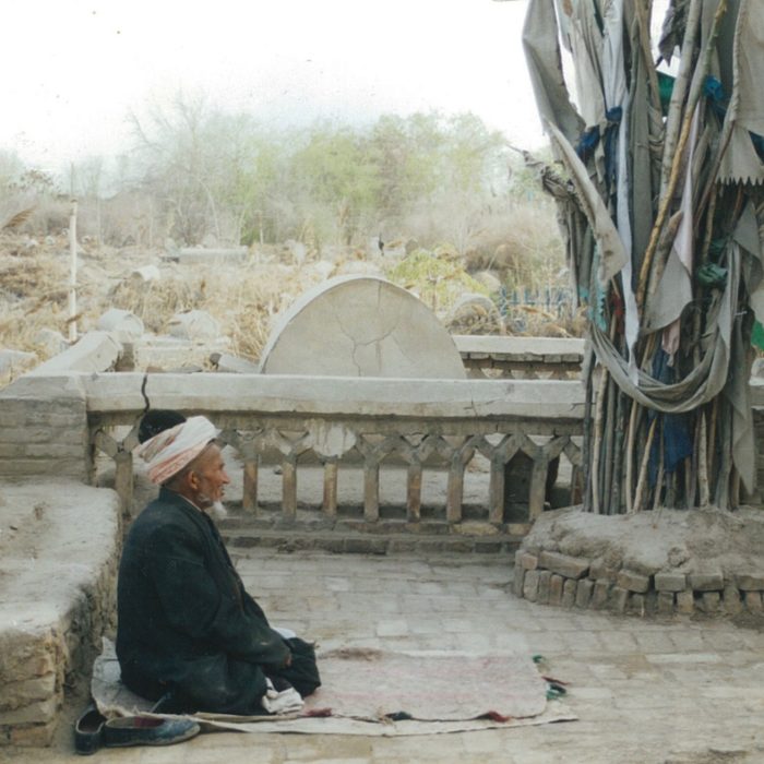 Devotee prays in front of shrine