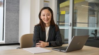 AGSM students working together from a laptop in a classroom on campus