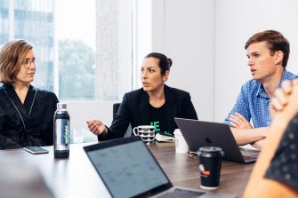 Group of people sitting in discussion at office table