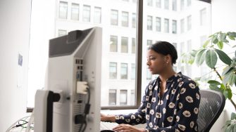 Woman in office looking at a computer screen