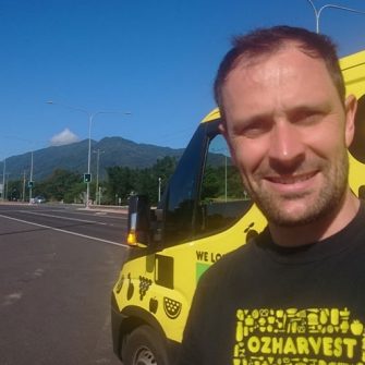 Ben stands in front of the Oz Harvest food van