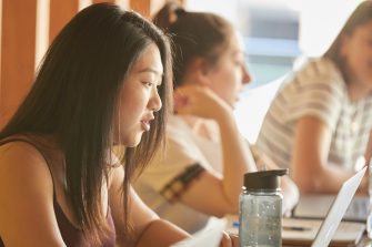 Students and teachers in business school computer lab