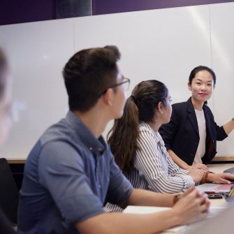 Students and teachers in business school computer lab