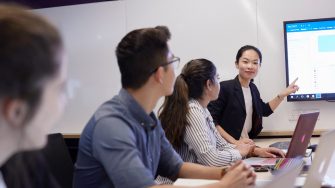 Students and teachers in business school computer lab