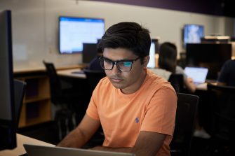 Students studying on computers in the business school computer lab.