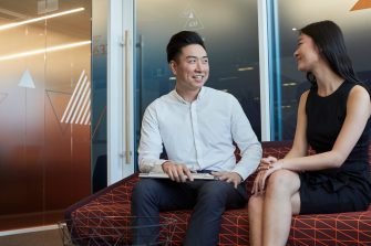 Post graduate students working on computers, talking and studying at the business school, Kensington UNSW