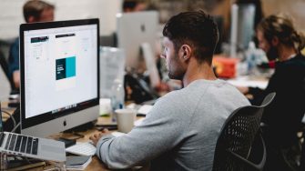 Man working on a Macbook in an office