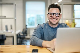 Man smiling over laptop