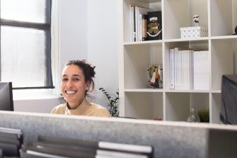 Woman at office desk smiling