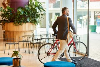 Shot of a businessman with his bicycle going home after work from office