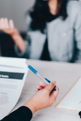ChatGPT chat bot screen seen on smartphone and laptop display with Chat GPT login screen on the background. A new AI chatbot by OpenAI. Stafford, United Kingdom, December 13, 2022.