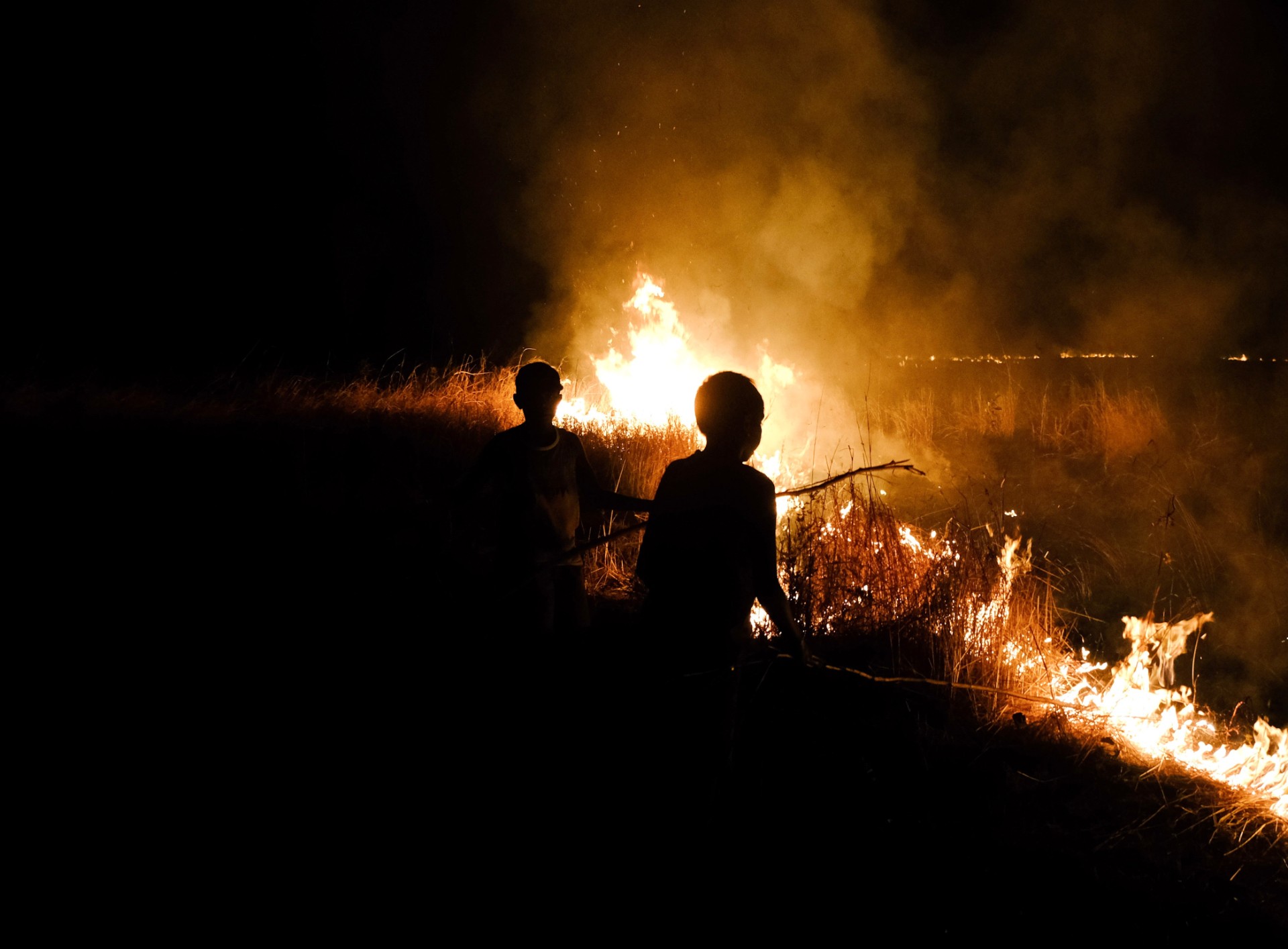 Indigenous Australians with a fire in a remote community.