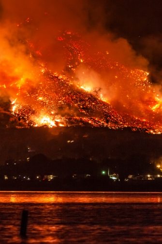 A large uncontrolled wildfire burns