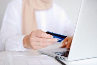Woman entering credit card details on a laptop