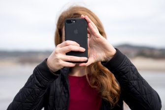 Young woman taking a photo with a phone